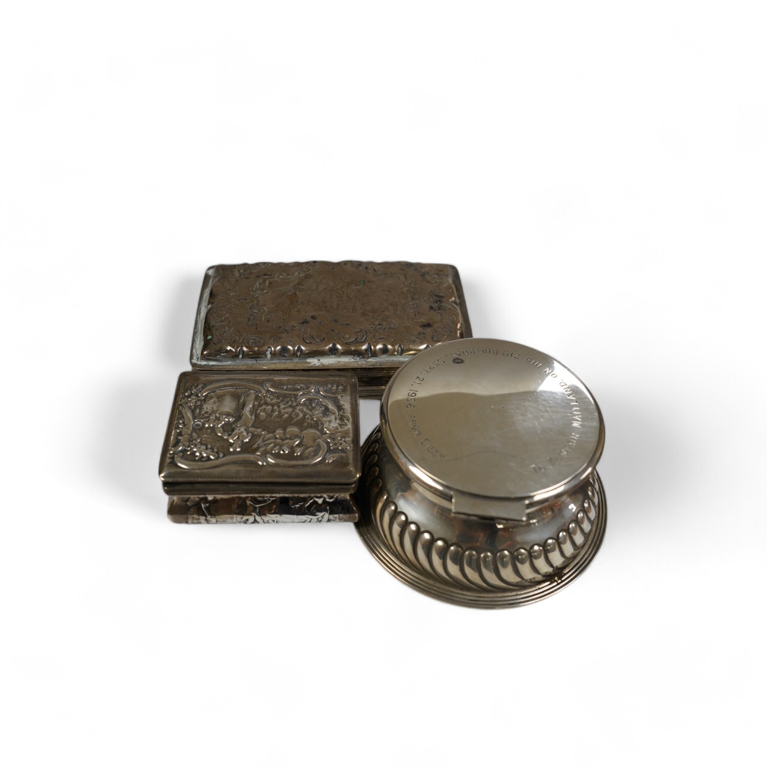 A late Victorian demi-fluted silver circular inkwell, with later engraved inscription, Birmingham, 1891, base diameter 11.4cm and two continental white metal boxes. Condition - poor to fair